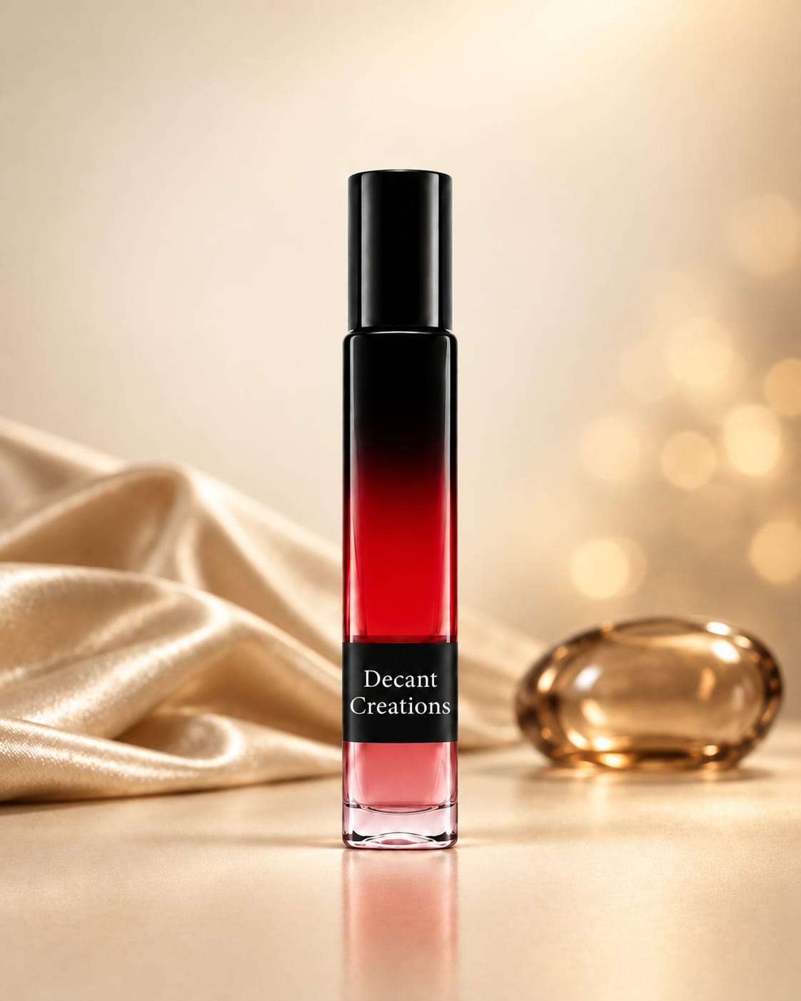 A slim black and red decant bottle labeled Decant Creations, on a cream backdrop